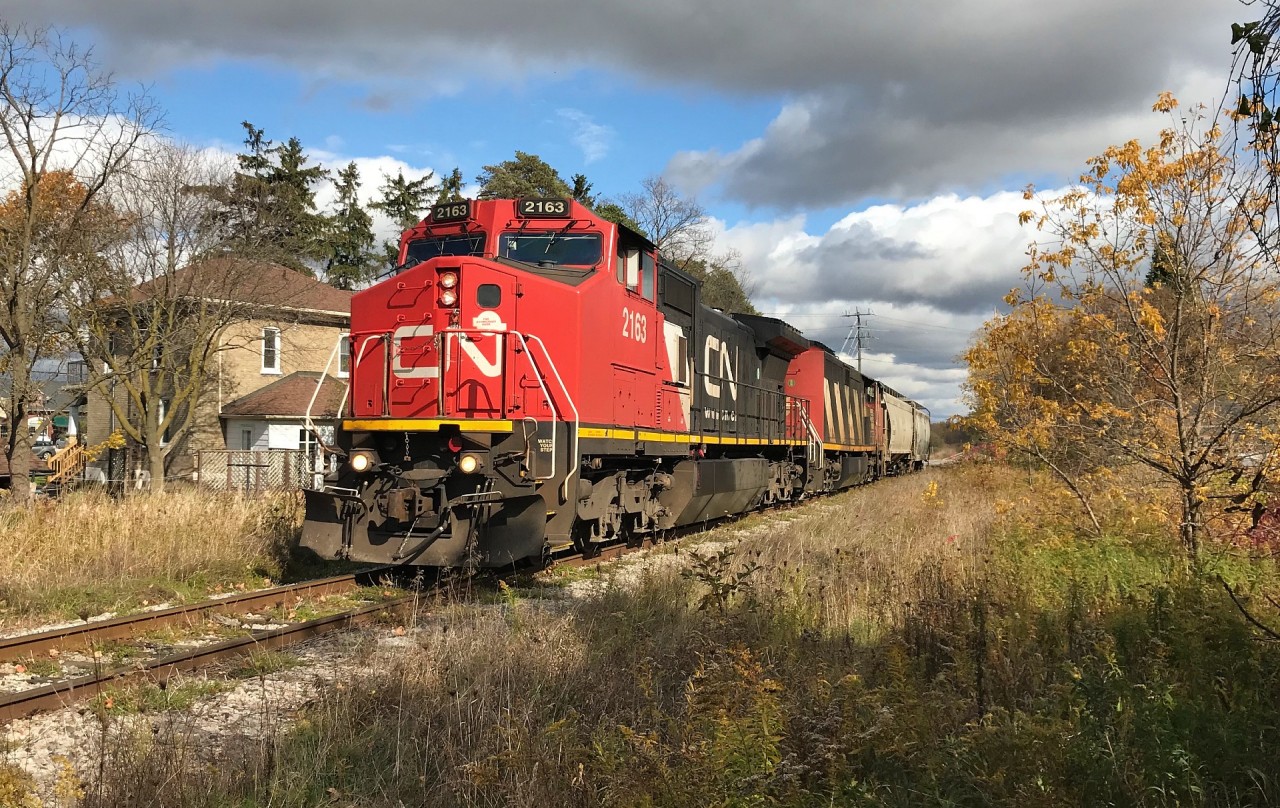 CN L568 with 2163 and 2417 is seen westbound at Baden, Ontario on the Guelph Subdivision with two cars during a brief sucker hole in the clouds. The train would go on to lift over 100 hoppers that had been previously stored at Stratford before proceeding to the CN yard in London.
