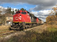 CN L568 with 2163 and 2417 is seen westbound at Baden, Ontario on the Guelph Subdivision with two cars during a brief sucker hole in the clouds. The train would go on to lift over 100 hoppers that had been previously stored at Stratford before proceeding to the CN yard in London.