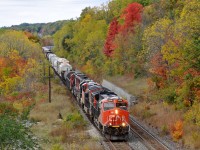 M39491 02 descends the grade through Dundas, ON with CN 3036, CN 3232, IC 1025, and CN 5447 leading 155 cars 