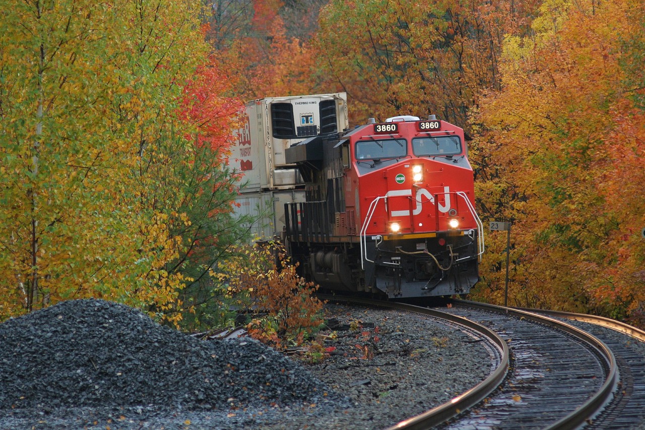 For just a few minutes the rains of a system that had lingered over the Northern Ontario town of Parry Sound had stopped. During the calm, the sun even tried it's best to come out, only to be overtaken once again by the dark clouds that seemed to be relentless during this trip. However, luckily in that short window of time, CN 3860 north made it's way across the DRZ (Directional Running Zone) and was able to beat the rains through town at it passed Mile 23 of CP's Parry Sound Subdivision.