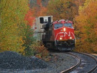 For just a few minutes the rains of a system that had lingered over the Northern Ontario town of Parry Sound had stopped. During the calm, the sun even tried it's best to come out, only to be overtaken once again by the dark clouds that seemed to be relentless during this trip. However, luckily in that short window of time, CN 3860 north made it's way across the DRZ (Directional Running Zone) and was able to beat the rains through town at it passed Mile 23 of CP's Parry Sound Subdivision.  