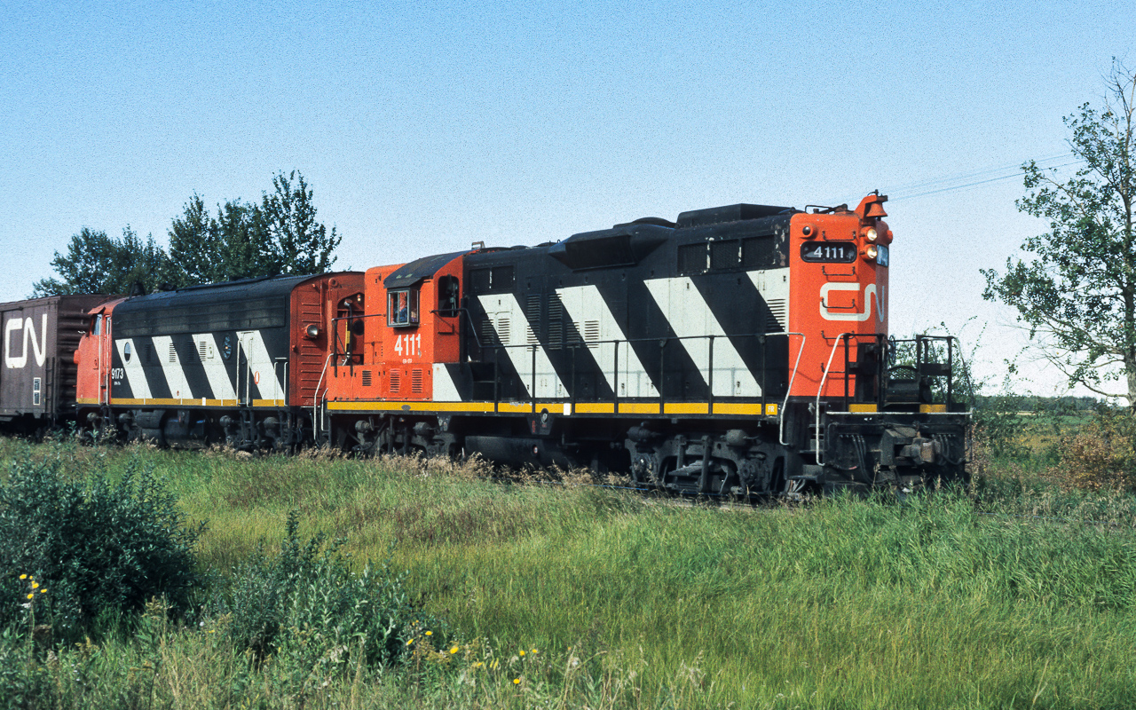 An early photo taken with my Canon TX on the west edge of Redwater. This is one of the few instances of my photographing a CN 4100. The vast majority of the units that came through town were the light branchline 42 and 4300 series loco's. As the 4111 will be renumbered to the 4370 in 1984, this helps confirm the date is 1983. Also, from the CNRHA, the 4370 will go for rebuilding into slug 233 in 1987.