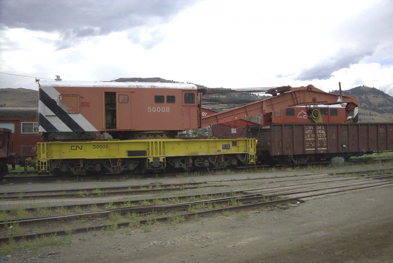 Further to the recent Bruce Lowe photo - Collection of the GHRA showing CN 50008 Bucyrus Erie 250 ton steam powered wrecking crane, serial number 36210, built in 1946, here is a glimpse of the same crane 37 years later at 56 years old in Kamloops, BC on August 1, 2002. In this photo the crane is now dieselized, has all new sheet metal wrapping the upper structure rotating deck, and is in the newest CN wrecking crane paint scheme.