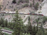 Photo of a CN express train in the Thompson river canyon about 7km north of Lytton BC. A small piece of the river can be seen in the lower right and the CP tracks in the lower left. The 5348 is being helped by the 5180 and 5079. Picture taken at the end of June.