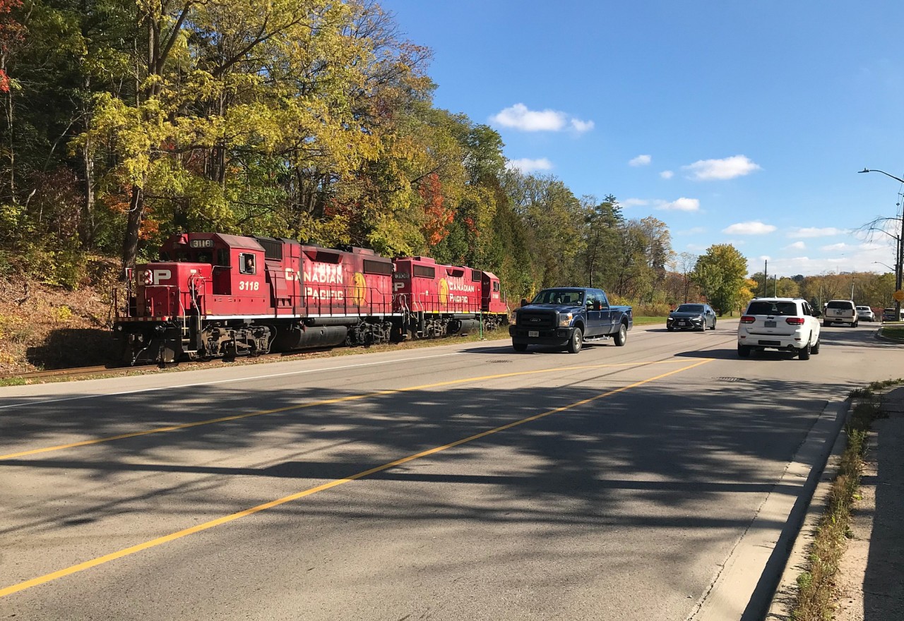 Canadian Pacific’s Hagey Job with GP38-2’s 3108 and 3118 are returning back to Cambridge at a leisurely pace as they parallel old King Street in Kitchener, Ontario. The pair had set-off cars for CN at the interchange at South Junction in Kitchener before departing light power to Hagey yard. October 19, 2019.