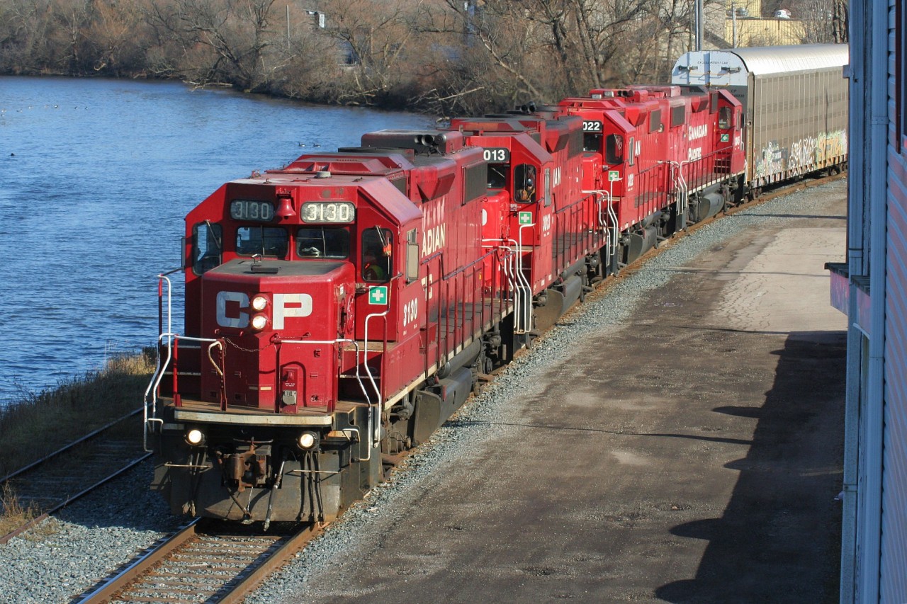 CP T72 slowly runs beside the Speed River in the community of Preston, Ontario in Cambridge on the Waterloo Subdivision. The train is fairly sizeable and will soon fill the nearby yard at Hagey. It is powered by CP 3130, 3013, 3022 and 3045.