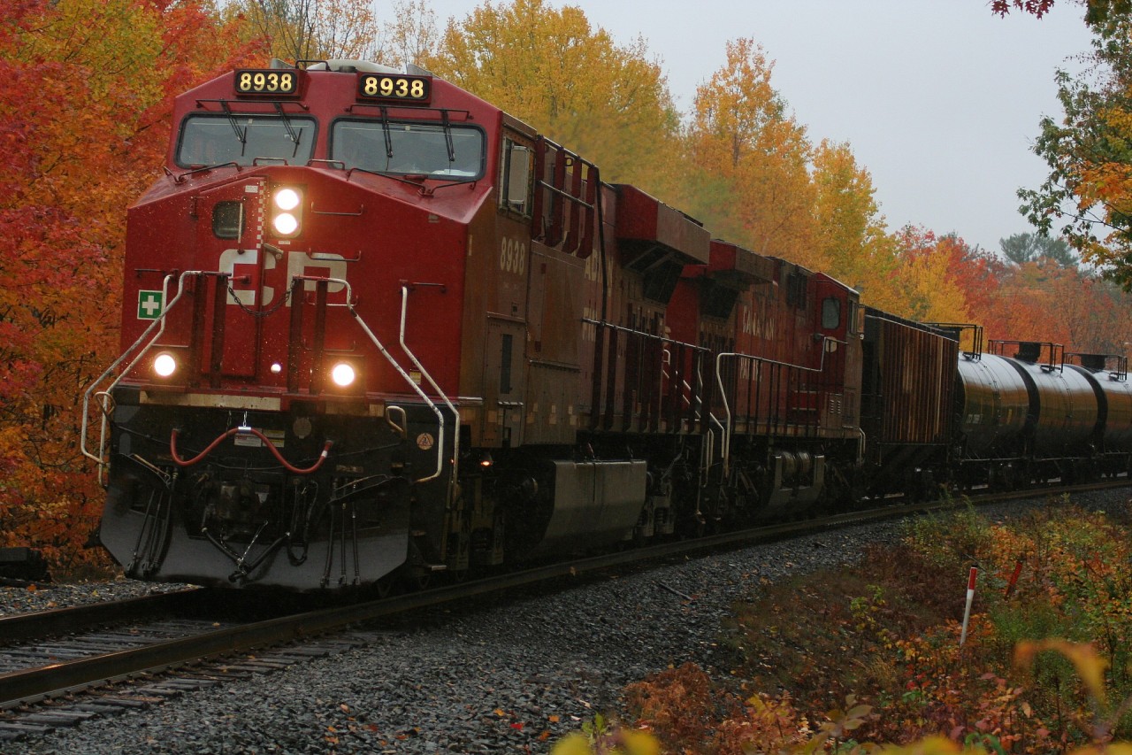 In an absoulte dreary rain storm CP 8938 charges northbound through Parry Sound as it approaches the Isabella Street crossing amid some amazing fall colours.