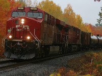 In an absoulte dreary rain storm CP 8938 charges northbound through Parry Sound as it approaches the Isabella Street crossing amid some amazing fall colours. 