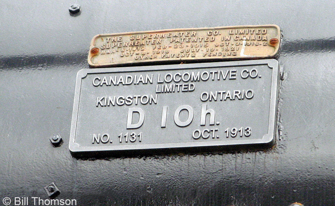 A closeup of the builder's plate and superheater plate on the boiler of CPR D10h 1095, on display at Confederation Park in Kingston. The unit was built by the Canadian Locomotive Company (CLC) at their Kingston ON factory in October 1913, and donated to the City of Kingston for display in 1965.