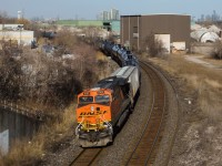 The CP Galt Subdivision from Guelph Junction to West Toronto has always been very captivating to me, neat views like this are a reason why. BNSF 6105 (GE ES44AC, built 09/2006) shoves on the rear of CP 650 under the Dundas Street underpass in Cooksville (Missisauga). Visible in this view is a former CP Rail transload facility, however I cannot recall it's purpose and when it was abandoned. Modern skyscrapers that make up the Toronto skyline are also visible. CP 650 is a train of ethanol loads bound for Albany, New York.