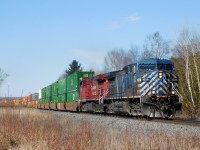 CP 118 led by CEFX AC4400CW #1029 heads eastbound towards Montreal along Canadian Pacific's Belleville Subdivision through Newtonville, ON approaching the East Townline Road crossing.