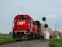 <b>Honda Racks</b>
<br><br>
On a nice June evening, CP T23 heads north out of Spence Yard with some empty open autoracks destined for the Honda facility in Alliston, just a mile or so up the line. Spence is always a nice spot to hang out at, as not only do you get mainline action but you usually can catch some yard movements in between the through trains, not to mention trains 420 and 421 both regularly work the yard here which can provide for some nice photo opportunities too. You can never go wrong with some classic searchlights either!