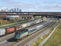 The rebuilding of the Turcot interchange and nearby roads and highway on and off-ramps is just about complete (part of the interchange is visible in the background) and that includes this overpass over CN's Montreal Sub, which opened just last week. Here VIA 35 with VIA 6407 and a mixed LRC/HEP consist passes some grain cars. Visible at far left is the skyline of downtown Montreal.