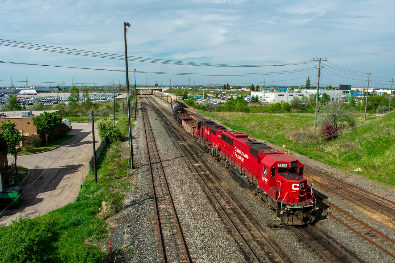 A very unusual T10 enters Toronto Yard on a nice sunny May Afternoon after lifting a considerable amount of stored autoracks in Trenton as the auto plants were just beginning to open up again after the COVID shutdown. The power selected for this rare move are both ex-SOO Line units, the leader being SD60 #6248 and trailing is GP38-2 #4407. Normally a T10 will simply just consist of one geep and a few tank cars.