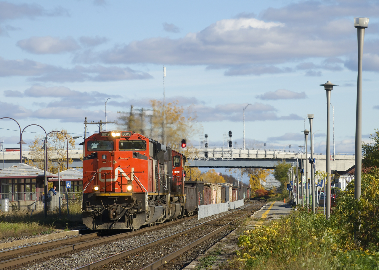 CN 321 has a pair of EMD's for power (CN 8019 & CN 5747) and 90 cars as it passes Dorval Station.