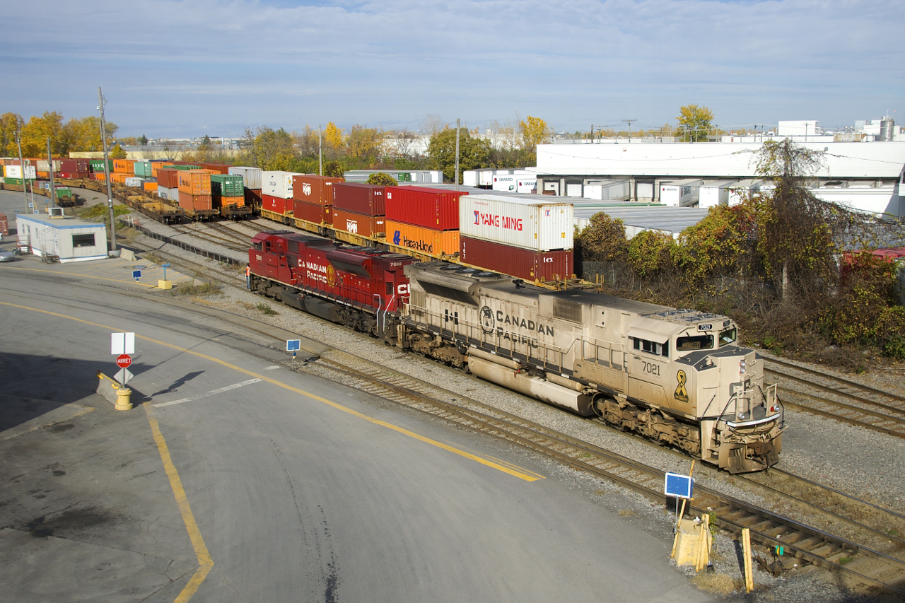 CP 143 has military unit CP 7021 and class unit CP 7000 for power as it backs into Lachine IMS Yard to lift intermodal traffic on an intermittently sunny afternoon.