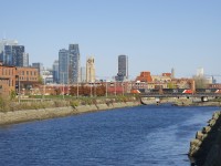 A 620-axle long CN 120 is crossing the Lachine Canal with CN 2293, CN 3106, CN 2666 up front and CN 3252 mid-train. Barely visibile in the far distance at left is a noodle on CN's headquarters in downtown Montreal.