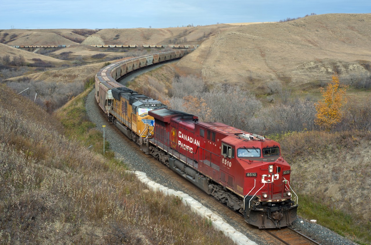 CP 3N08 is notched out as it climbs out of the valley at Craven Saskatchewan. UP front are 8510 and UP 5028, 9768 mid train, and manned helpers 6241, 6249 pushing hard on the rear. If you look closely you will see that this shot gets two thumbs up from the engr.
