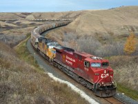 CP 3N08 is notched out as it climbs out of the valley at Craven Saskatchewan. UP front are 8510 and UP 5028, 9768 mid train, and manned helpers 6241, 6249 pushing hard on the rear. If you look closely you will see that this shot gets two thumbs up from the engr. 