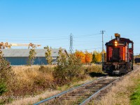 AbitibiBowater 1305 leaves the confines of the large paper mill, ambling alongside the parking spaces and across from the storefronts on Ambridge Drive in the small northern Ontario community. Just like clockwork, they are coming out to greet the now twice weekly ONR freight at the town's rail yard. This ritual will end in a little over four years when the newly restructured forestry company now named Resolute Forest Products will shutter this mill operation days prior to Christmas 2014. Sometime in the years following this picture the 1305 would leave the property and emerge at <a href="http://www.railpictures.ca/?attachment_id=27476">Resolute's Allanburg operation</a> sporting new paint (and lacking the sponges on exhaust stacks!) 