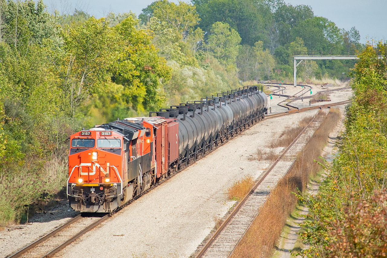 I love railfanning Niagara for its combination of interesting interchange moves and spaghetti bowl of track, and this is a great example of both. CN L562, with CN 3157 on point, is not far removed from the Cayuga Spur Connecting Track and having entered the CP Hamilton Sub at Brookfield East, and is now 'northbound' on the Hamilton Sub headed for interchange with Trillium at Feeder (accessed from the north switch for Rusholme Siding). I did a telephoto here to emphasize the track configuration in this area. The track at right is Rusholme Siding (which is usually jammed full of racks so to find it empty for a clear shot of 562 is a nice bonus), the switch nearest the tail end of 562 is for the Montrose Spur which is traversed twice weekly by TE21 heading to Niagara Falls, and the first switch to come off of the Montrose and head towards the middle of the disused signal bridge is the Stevensville Spur (formerly Fort Erie Sub). The Stevensville Spur rarely sees anything on it - earlier this Spring at the height of COVID shutdowns it was jammed full of autoracks, but has long since been cleared. As far as I know these were the first wheels to turn on these rails in at least a couple of years. In a short distance, 562 will pass underneath the CN Stamford Sub, the very rails it was on just minutes before.