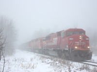 The headlights of SOO Line SD60M 6058 pierce through the thick fog as it leads a southbound tank train just south of Guelph Junction. The trailing SD40's were sold to the DME years earlier even though they still carry CP action red. A leased GCFX SD40 is fourth in the consist. Their was a time when unit tanker trains were common on the Hamiton subdivision, but those days are long gone now. 