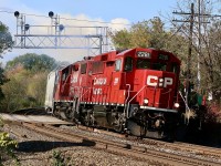 It truly amazes me how much things change over the years. I first started railfanning Streetsville back in the mid 1990's, back then the village was served by CP from Guelph jct. Typically Monday-Friday a line C424 or RS18U would be the power, when the Alco's were retired leased GP40'S replaced them. By then the OSR took over CP's contract to serve Guelph and both local assignments no longer call Guelph Junction home. The Streetsville turn then started at West Toronto. As the years passed the brief use of leased GP40's ended and rebuilt GP9U'S replaced them. The economic termoil of the late 2000's forced the temporary closure of West Toronto yard and the Streetsville turn moved to Agincourt yard. Eventually West Toronto yard reopened and T14, the streetsville turn returned to the yard. Not long after the GP9U'S were retired and GP38'S and new GP20ECO's replaced them. As for Streetsville, rail service over the years has gone from daily to Monday-Wednesday-Friday device, and while a few new customers have surfaced over the years, almost double have left. Nevertheless T14 is still one of my favorite locals. Here T14 has finished it's work under mostly rainy skies, which have finally cleared for the trains departure. On the way home the train will meet both trains 651 and 246. This power set has been around most of the summer so I'm hoping the white smoke from the trailing unit might mean some shop time ahead, and finally a new power set. 