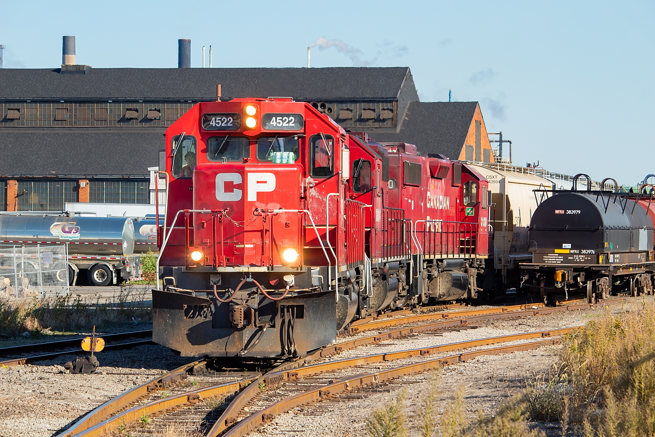 After spending an hour or so switching out Bell & MacKenzie, the crew of CP TE11 (Welland crew in Hamilton on Saturday) re-emerges, destined for Kinnear after a relatively short time down the Belt. The coils at right would later be lifted by CN, having recently been worked on at Railcare, and heading for Stelco after a layover in Stuart. The building in the background I believe is Ingersoll Tillage.