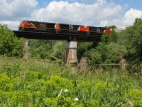 GEXR 431 rolls over the Grand River in Breslau, ON with the usual trio of...wait.


Times have changed, and CN is running the show again on the Guelph Subdivision. With 533 running 3 days a week as far as I'm aware, this brings massive trains and with it, a clogged Kitchener yard. CN is normally able to complete this Mac to Kitchener, and return move with just 2 units, rather than GEXRs trio of EMD war heros and a shorter daily train. That being said, its a bit difficult to re-create a shot with matching, or at least somewhat matching trios of CN. The fact this train normally runs at night makes the shot a bit more hard pressed to get too. Luckily, I was told of a daylight 533, and head to the Grand River to get set up. After seeing that trio of GEXR for years, I never thought I'd be re-creating it with CN...crazier things have happened I guess.