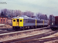 35 years ago today, VIA 663 (today numbered 85) is seen westbound through CN Guelph Junction.  If on the advertised, the time would be 1206h.  At right, cars are spotted in track XW22, one of the two loading tracks at the Guelph Jct. freight shed, the other being XW23 going out of frame at lower right.  To the left the piggyback ramp can be seen which still survives today, though buried under piles of track materials and dirt.  Behind the ramp is the Guelph Twines facility, served on <a href=http://www.railpictures.ca/?attachment_id=42811>track XW36.</a>  Long a face at the junction, the building, dating to at least 1929, has housed small motor companies from 1929 – 1972, starting as Leland Electric, becoming part of Sangamo Electric circa 1960, and finally as Prestolite from 1970-1972.  Guelph Twines took over the building in 1972 after moving to Guelph from Brantford. The company still operates from this building today, receiving hopper cars from CN just a handful of times per year.  Until steel siding went up around 2010, the words “Terminal Warehouse” could be faintly made out in old paint on the track side.  Since 1971, the basement of the building has been home to the Guelph Model Railway Society.<br><br>VIA 6216 is an RDC-2, built in March, 1955 as RDC-3 <a href=http://mountainrailway.com/Roster%20Archive/RDC/CP%209000/CP%209022-3.jpg>9022 for Canadian Pacific,</a> before being sold to VIA Rail in September, 1978.  In October, 1981, 9022 would be rebuilt and renumbered at CN's Transcona Shops in Winnipeg from an RDC-3, with capacity of 48 passengers, RPO, baggage, into an RDC-2 by removing the RPO section, and increasing seating capacity to 70 passengers.  It would emerge as VIA 6216, and continued in service until being retired and sold in 2000 to Industrial Rail Services in Moncton.  It would be scrapped in 2016.  An interesting note is the second RDC, painted with yellow VIA ends, but retaining the CN black stripe along the window section, and lacking blue VIA stripes on the lower section.<br><br><i>Peter Raschke photo, Jacob Patterson collection slide.</i>