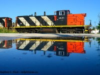 A pair of GMD-1's reflected in a small puddle as 551 works the Milton Town Spur. It has been a treat to have these roaming around our area for the last few years. 