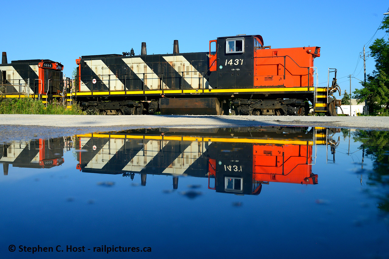 A pair of GMD-1's reflected in a small puddle as 551 works the Milton Town Spur. It has been a treat to have these roaming around our area for the last few years.