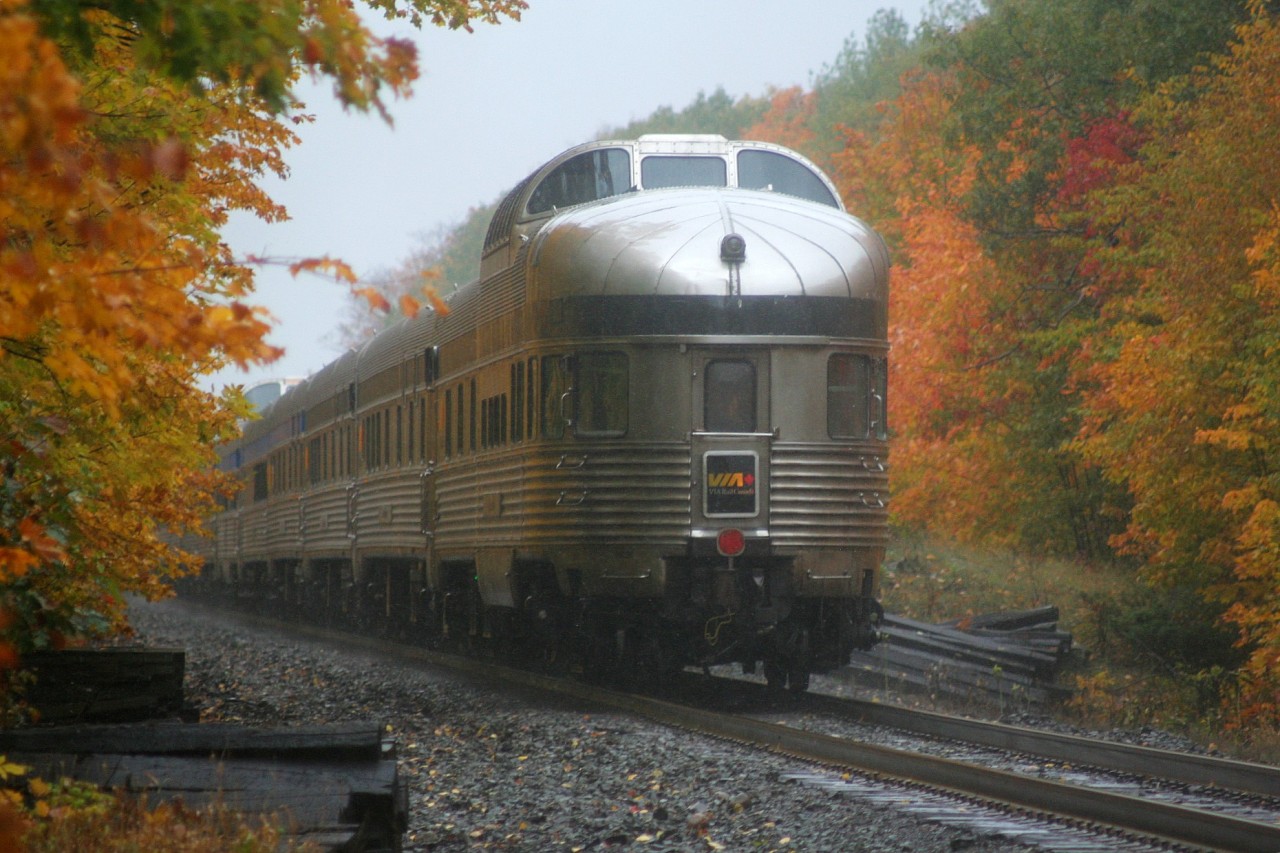 VIA Rail train #1, the Canadian, with 6435 and 6434 has completed their station stop at the historic Parry 
Sound station on Canadian Pacific’s Parry Sound Subdivision. Here the train is seen exiting town as it continues it's Northern Ontario jounrey through the speldid fall colors during some continous rain showers.
