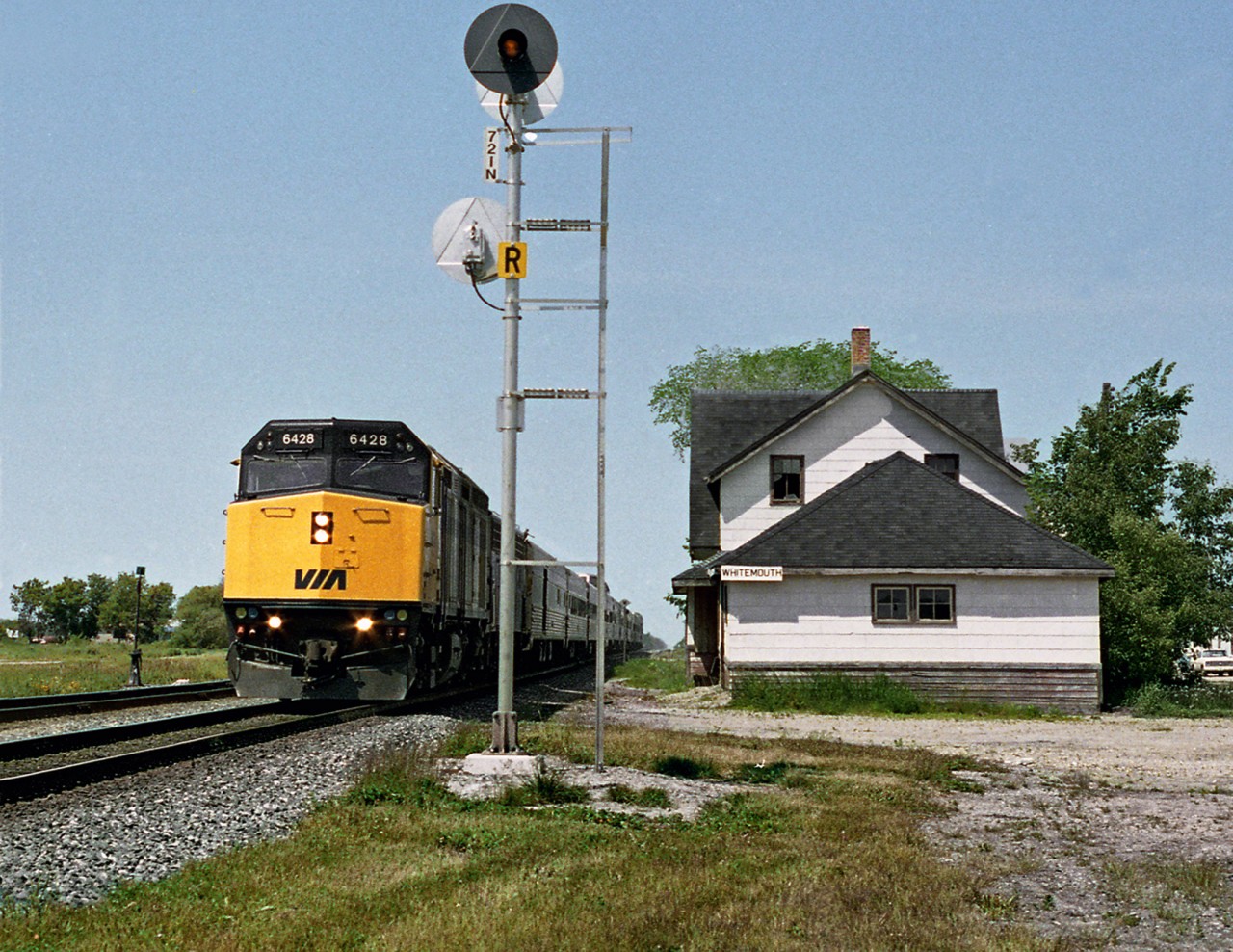 The eastbound "Canadian" hiballs past the unused Whitemouth station east of Winnipeg. CP had left hand running on it's double track between Winnipeg and Thunder Bay. This was due to 2nd track constructed around 1912 to the north of existing line and had grade separated segments to ease grades for primarily loaded eastbound tonnage
