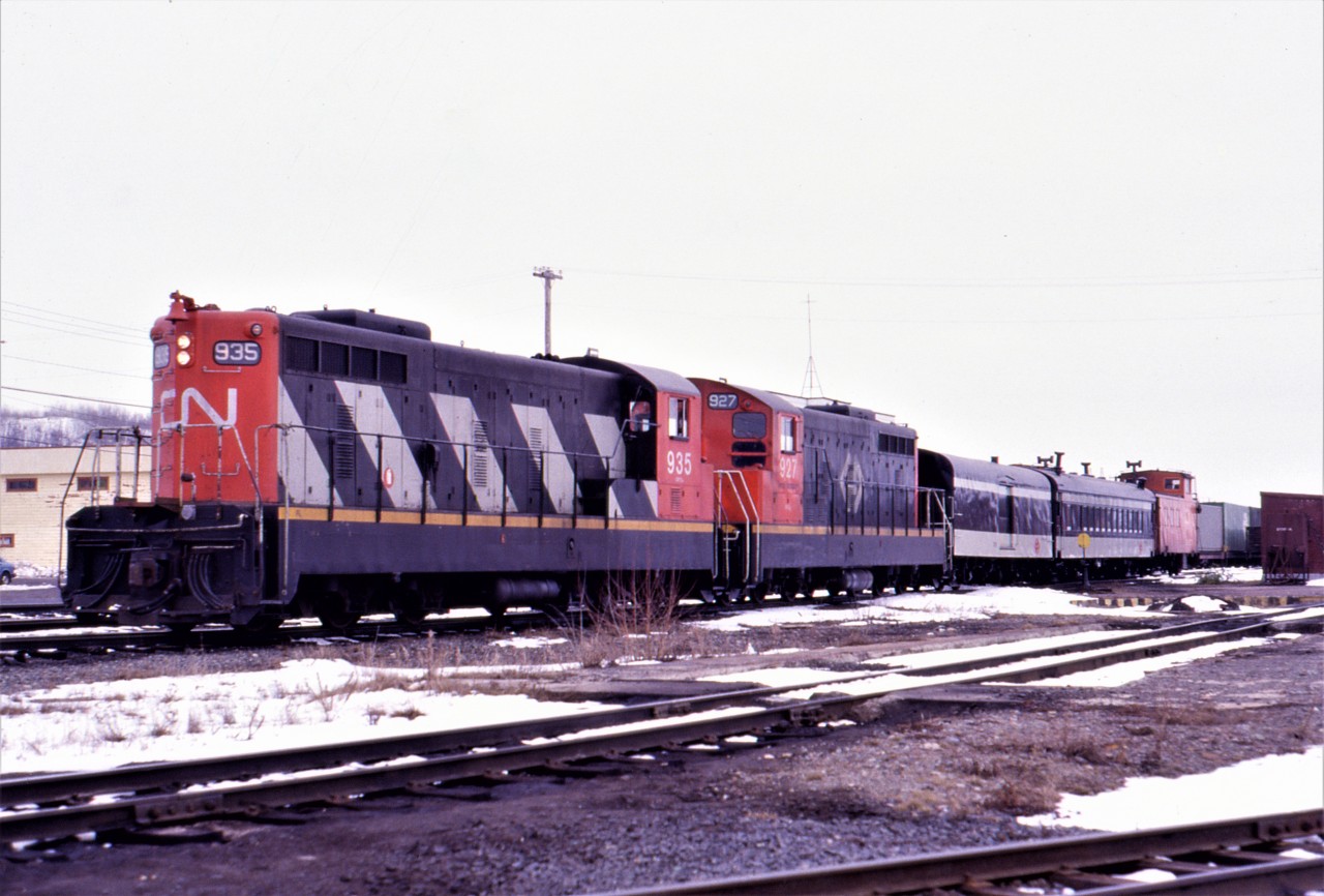 MARSHALLING THE MIXED - The engineer of Mixed Extra 935 West has just finished marshalling his train at the Bishops Falls yard on April 16, 1988. Within minutes, he will pull ahead and back into the station so that the photographer and his friend Paul, the only two passengers for the complete 138 mile journey to Corner Brook, can board. At Millertown Junction, the mixed will stop to allow Brad Lingard, son of former railroader turned author Mont Lingard, to board until he reaches his cabin at Gaff Topsail. Some 26 years later when shooting retakes for my second book, RAILS AROUND THE ROCK I am invited to Mont's Cabin and meet up again with Brad. We discuss our meeting years earlier and he then amazingly produces a journal where he had recorded meeting the two fellows from St. John's on the mixed on April 16, 1988!