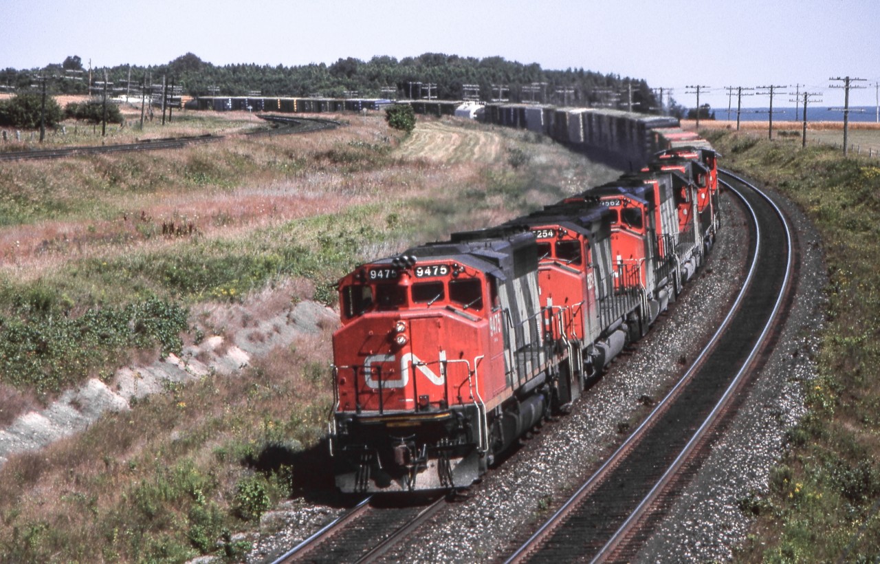 CN 9475 leads a westbound freight in Newcastle, Ontario on July 31, 1987.