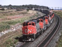 CN 9475 leads a westbound freight in Newcastle, Ontario on July 31, 1987.