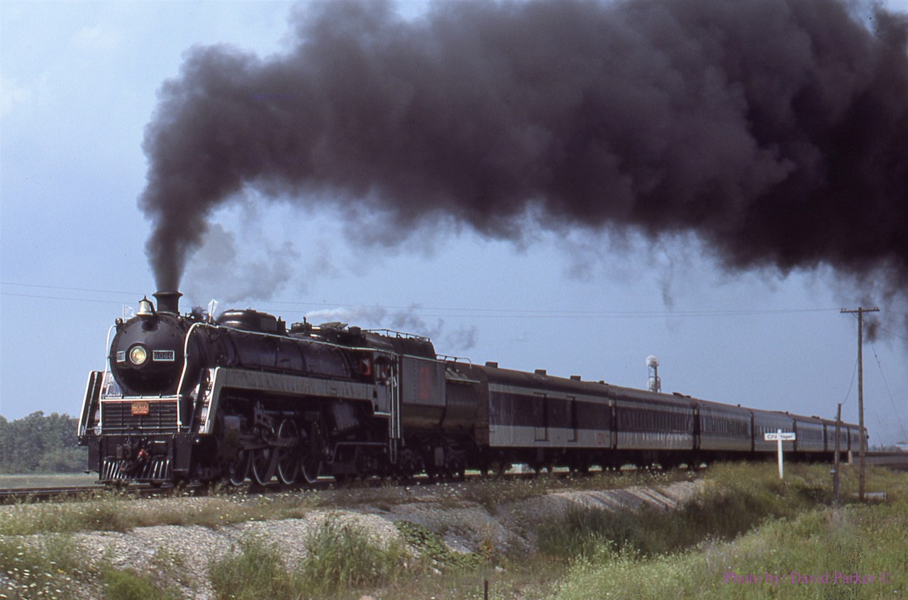 Only ten days before Arnold Mooney's shot of CN 6060 passing over the CN Cayuga/CR Canada Div tracks (Photo 42283) I had ridden the sidetrip from the Falls to Yager with my cousin Steve, who is now a driver at GB Railfreight in the UK. I was 17 when I took this shot of the run-by at Yager.  You can see the last coach is still on the bridge shown in Arnold's photo.
