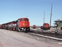  A Westbound freight departs Mac Yard from the "Green Tower" heading towards the Halton Outbound. The two EMDX units are Ex GO Transit GP40's. 