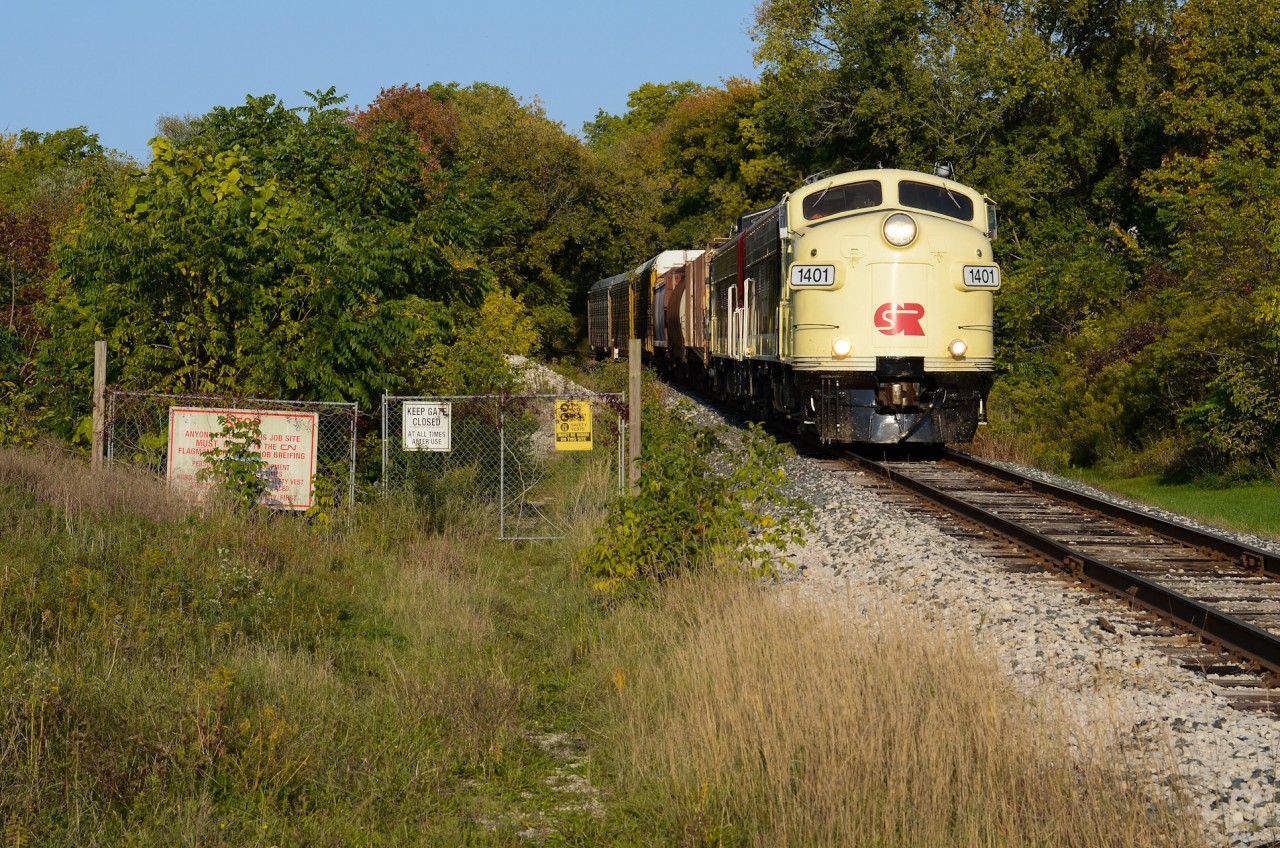 Just east of Downtown Ingersoll, the pair of former CN F units owned by the OSR roll into town with traffic from CP T69 in Woodstock. The CN noodle on the sign guarding the former site located beside the OSR/CN interchange which is out of frame provides a well composition in my eye with the history of these motors. With the F units having the most CN related history on OSR’s roster, I thought this shot would be the best fitting with these units on this very clear October evening - a great start to a good weekend. Was a good chase this day with good people and I’m pretty happy this shot is checked off for me. Anyone have info on the site that this gate was protecting?