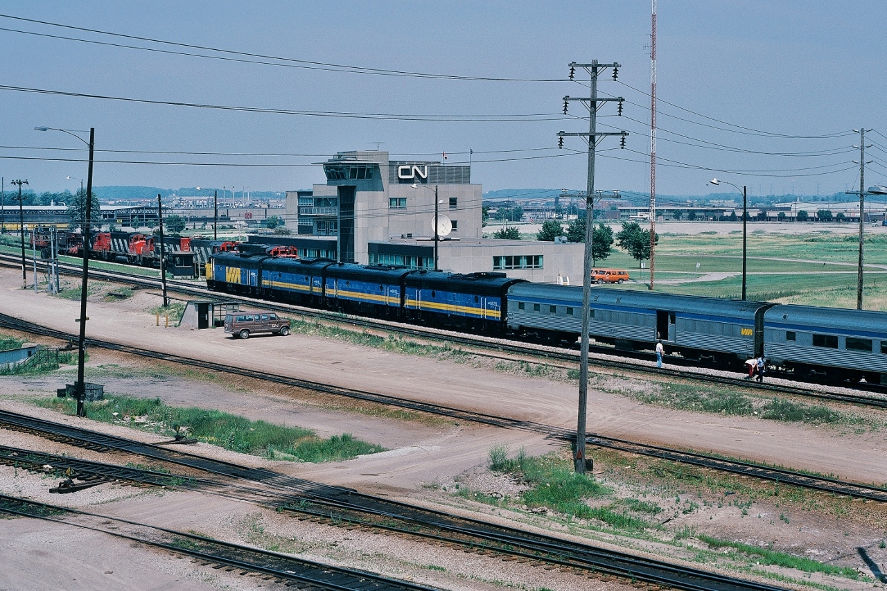 how about your most interesting rail fanning Kodachrome* 'capture' ? This one is in my 'top ten' ….


 The July 6 Plan: Capture – on Kodachrome - VIA #9  prior to departure at Union, then capture #9 at the Snider diamond** on the Newmarket....


 ….except #9 took an unexpected detour....into Mac Yard !


 at CN MacMillan Yard:  VIA #9, Toronto section  of  'Canadian' ,  July 6, 1986 Kodachrome by S.Danko


What's interesting:


 at Union VIA#9 operating crew attempted to repair leaking steam line between the baggage and first coach....


 ….after some discussion the stop at Mac was arranged to allow the CN pipefitters to attend to the matter


 July 6 1986: VIA#9 power:  6502 - 6610 - 6612 - 6635  ( FP9A – F9B – F9B – F9B )


 VIA#9 and #10 were daily on the Newmarket Subdivision with scheduled passenger stops at Newmarket, Barrie, Orillia, Washago then north of Washago onto the Bala. 


  in the background: that CN lashup includes 9523 – 5039 – 95xx – 9449 – 4229 ( GP40-2L(W) /  SD40 / GP40-2L(W) /  GP40-2L(W)  / GP9 )


 * ok, ok, many of you have missed the joy ( & or dismay ) of waiting for that little yellow box...


 ** Snider diamond replaced, by Metrolinx , with a rail separation – Newmarket over the York Sub – completed 2007ish.


 perhaps those in the know may explain the inbound / outbound  trackage at the Mac tower ? ....


sdfourty