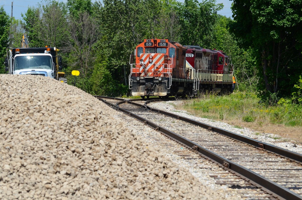 On a very humid June afternoon, I hear Job 1 on the radio at the wye ready to spin the power to run around their train sitting on the interchange along Edinburgh Rd. In Guelph anyway, I quickly made my way down Dawson Rd to the west end of the wye just to get there to the conductor throwing the switch to pull down the wye to the south end of the interchange with about half a minute to spare as I got out of the car. Framed with the ballast and construction equipment on the left presumably for the new interchange track that was going in behind me which is now in use today, multimark coloured 1591 trails 1620 facing the perfect sun as they proceed with their movement down the wye with the conductor riding porch side 1620
