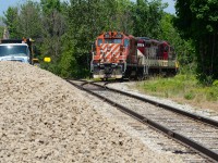 On a very humid June afternoon, I hear Job 1 on the radio at the wye ready to spin the power to run around their train sitting on the interchange along Edinburgh Rd. In Guelph anyway, I quickly made my way down Dawson Rd to the west end of the wye just to get there to the conductor throwing the switch to pull down the wye to the south end of the interchange with about half a minute to spare as I got out of the car. Framed with the ballast and construction equipment on the left presumably for the new interchange track that was going in behind me which is now in use today, multimark coloured 1591 trails 1620 facing the perfect sun as they proceed with their movement down the wye with the conductor riding porch side 1620