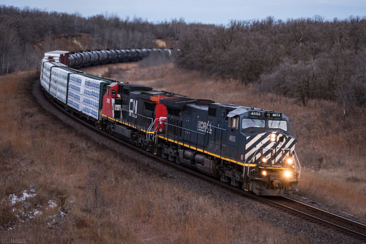 Grants Cut in Rivers Manitoba is a popular spot among train enthusiasts and non-train enthusiasts. The opportunity to shoot a BCOL C44-9W in that location was not being passed up. M312 Arrived in Rivers very early in the morning and was rounding the corner at the very first bit of light the sun was providing.