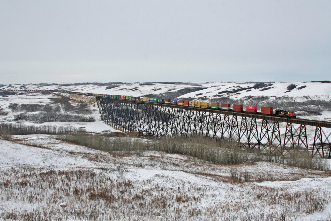 Q 10251 21 soars across the Battle River Trestle in Fabyan, Alberta with CN 3039 on the point and CN 8821 in the middle of their 164 car train.  The Battle River Trestle stands 195ft above the valley floor and is an impressive 2775ft long.