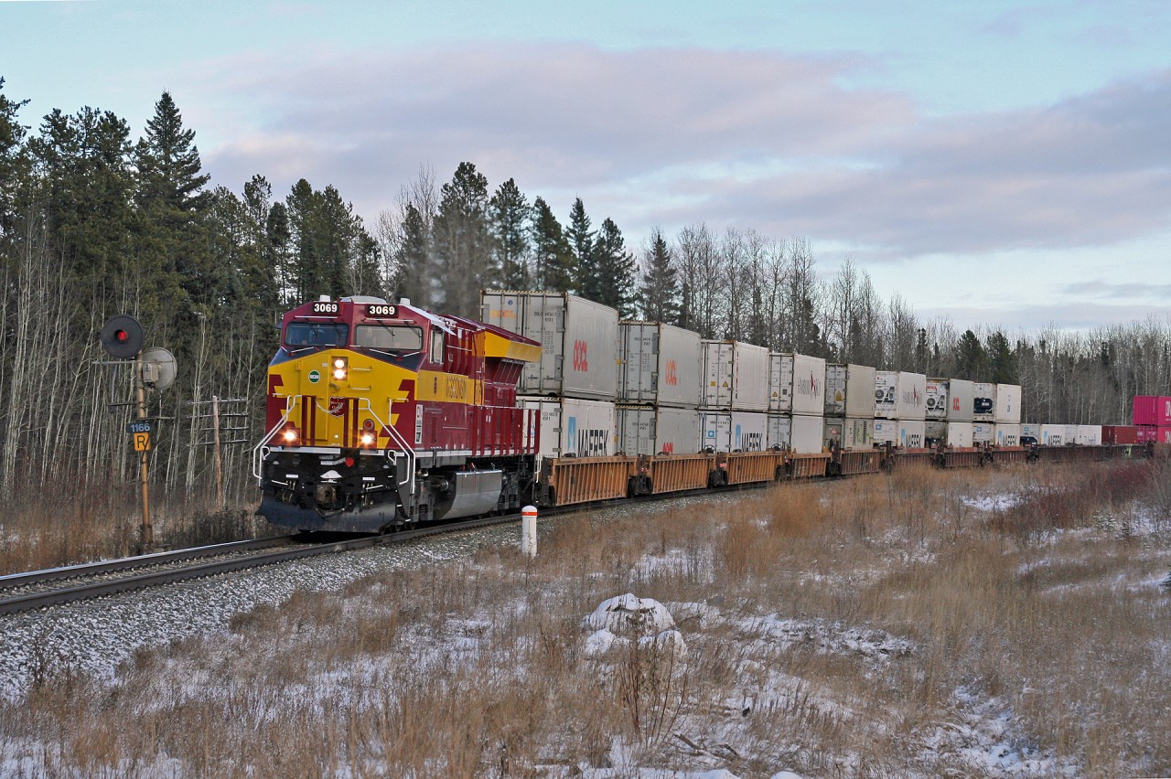 Q 11791 21 with the Wisconsin Central heritage unit, rolls through Rosevear, Alberta after meeting 180 at Peers.