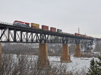 CN 3115, the BC Rail heritage locomotive soars across the North Saskatchewan River and into Edmonton, Alberta, with train Q 18331 20 in tow. Upon arrival at Walker Yard, the 3115 and mid-train remote CN 3818 will be fueled, while a quick crew change is performed.  Within the hour, Q 183 will depart for Prince Rupert, British Columbia with 143 intermodal cars for the port.  While not operating on former BC Rail territory, the locomotive will be making its first appearance in it's namesake province.  