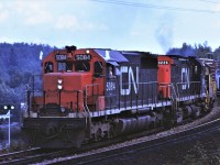 CN train 301 pulls down the passing track at Laforest, Ontario for a meet with an eastbound.  Power for the train is SD40 5084 C424 3226 and Precision National GP7 970.