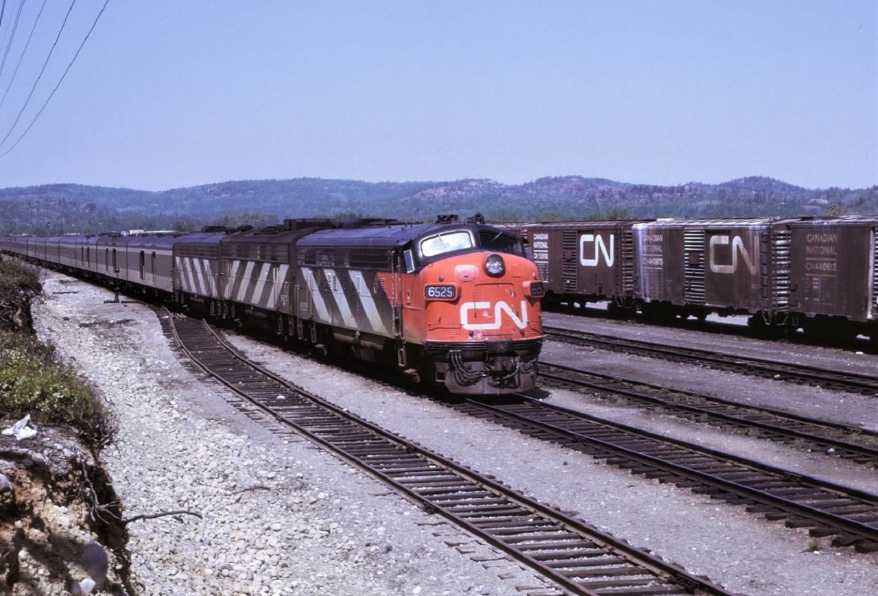 Canadian National's Super Continental, train # 2, behind a typical A-B-B set of General Motor units, arrives in Capreol, Ontario.  In less than a minute the train will be stopped at the station.  Power for the train was 6525-6637-6619.