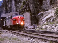 This photo was taken by my Dad in the summer (July?) of 1963 (thank goodness for dates stamped on Kodak slides). The exact location is not firmly known. Hells Gate gives easy access to the tracks from the highway and there is a tunnel entrance located right there. Thus I feel fairly confident that this is the picture location. Looking on Google Earth, there doesn't seem to be any other points offering a Dad an easy route while he leaves the family in the car. The 9124 was built in Nov./52 and 3 years later (March/66) it will be involved in a rock slide wreck. Oddly enough, this wreck was only several miles north of here at Boothroyd. It was retired shortly afterwards.